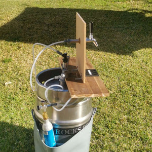 50l keg with tapping kit built into a piece of wood to make a bar
